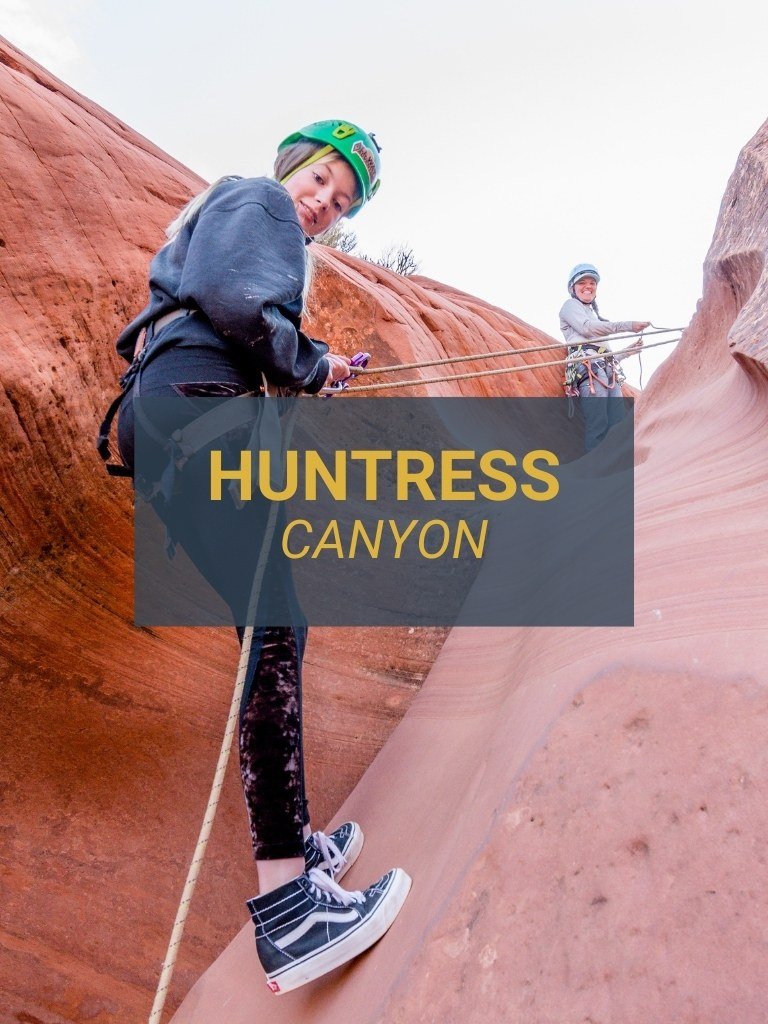 Woman rappelling into Huntress Canyon with an All Ways Adventure guide