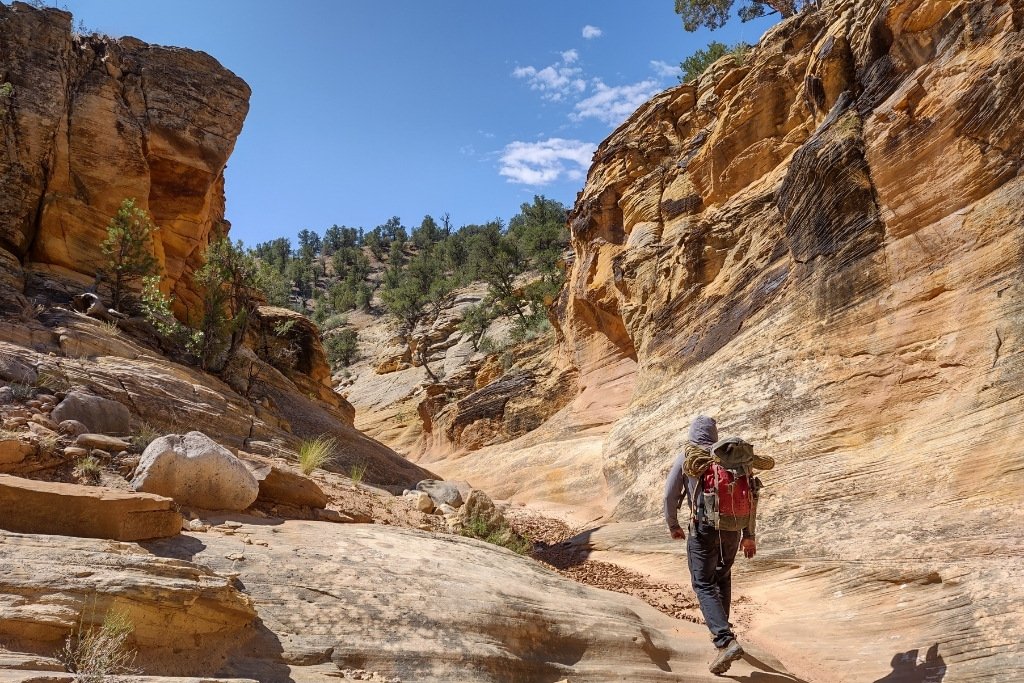 Man with backpack hiking the canyons in Southern Utah
